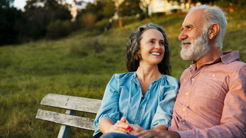 Senior couple smiling on bench
